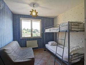 a room with two bunk beds and a window at Gîte rural avec jardin, parking et WiFi - Saint-Romain-en-Jarez - FR-1-496-295 in Saint-Romain-en-Jarez
