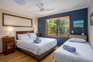 a bedroom with two beds and a window at Peninsula in Sawtell