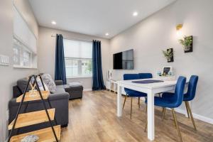 a living room with a table and a couch at Downtown Dunedin Tiny Home w/ Pool in Dunedin