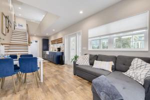 a living room with a couch and a table at 719 Douglas Avenue, Unit D "Skye" in Dunedin