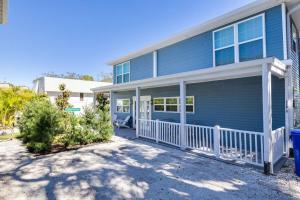 a blue house with a porch with a white fence at 719 Douglas Avenue, Unit D "Skye" in Dunedin
