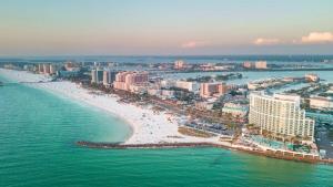 an aerial view of a beach with buildings and the ocean at 719 Douglas Avenue, Unit D "Skye" in Dunedin