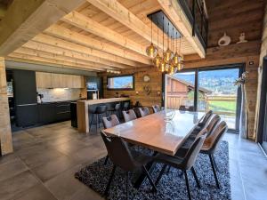 a kitchen and dining room with a wooden table and chairs at Chalet grand confort avec sauna et balnéo - Proche stations de ski - FR-1-589-762 in Xonrupt-Longemer