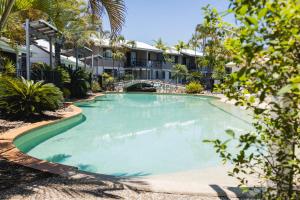 a large swimming pool in front of a building at Ivory Palms Resort Noosa in Noosaville