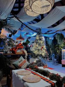 a christmas room with a christmas tree on a table at Siam Cookies Cottage in Haad Pleayleam +124 photos