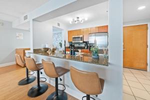 a kitchen and living room with a bar and chairs at Oceanview Haven Spacious Inviting for 8 Guests in Miami