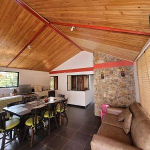 a living room with a table and a couch at NATURALEZA Y VIDA in Aquitania