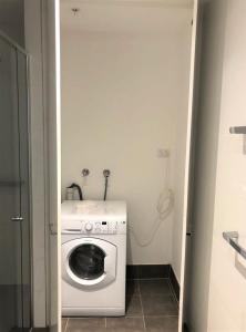 a washer and dryer in a small room at One Bedroom Private Apartment at 88 Archer St Chatswood in Sydney +4 photos
