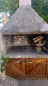 a brick oven with a pile of wood in it at Casa hasta 5 personas in Villa Carlos Paz