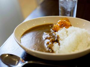 a bowl of food with rice and a spoon at Meitetsu Inn Nagoya Nishiki in Nagoya
