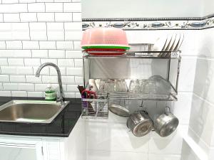 a kitchen counter with a sink and utensils at Dolee House in Phan Thiet