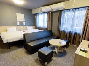 Un ou plusieurs lits dans un hébergement de l'établissement Hotel Route-Inn Miyako