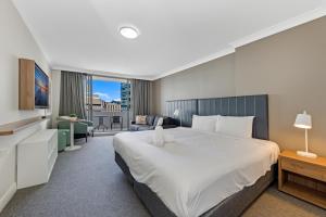 a bedroom with a large bed and a living room at Serain Chatswood Central in Sydney +62 photos