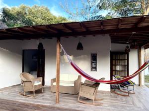 a hammock on the deck of a house at Río Celeste Poshtel Tayrona - Zaino in Calabazo
