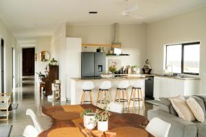 a kitchen and living room with a couch and a table at Beautiful Beaufortia in Denmark