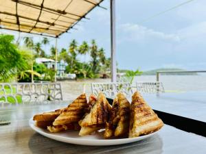 a plate of toast on top of a table at GS Home on the Bay - Super Sea view glass studio apartment in Vagator