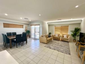 a living room with a table and a dining room at Hideaway on Peel in Busselton