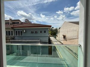 a balcony with a view of a building and a street at Prime Suite at Ampang - Individual Private Rooms in Kuala Lumpur