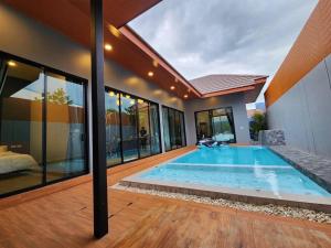 a swimming pool in the middle of a house at Bluda Poolvilla B in Hat Yai