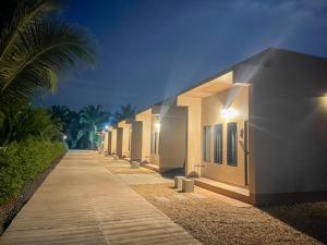 a row of houses on a sidewalk at night at jj home resort in Phun Phin