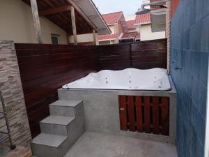 a bath tub sitting on top of a building at Aconchego chalé 59 in Mairinque