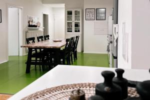 a dining room with green flooring and a table and chairs at Dohna, App 117 in Pirna