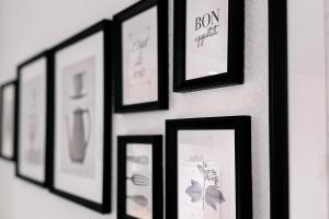 a group of framed pictures hanging on a wall at Dohna, App 117 in Pirna