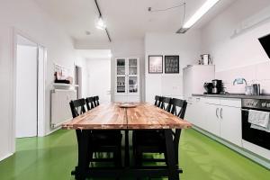 a kitchen with a wooden table and black chairs at Dohna, App 117 in Pirna +18 photos