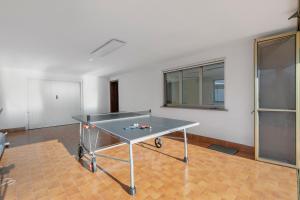 a ping pong table in the middle of a room at Casa Antonia - Happy Rentals in Porto Valtravaglia