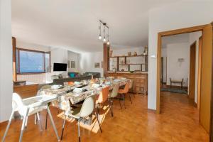 a dining room with a long table and chairs at Casa Antonia - Happy Rentals in Porto Valtravaglia