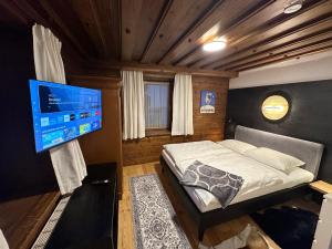 a bedroom with a bed and a flat screen tv at Kitzbühel City Appartement in Kitzbühel +46 photos