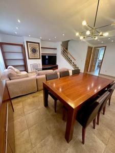 a living room with a wooden table and a couch at Chalet Borriol Golf REF 028 in Borriol