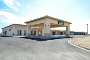 a gas station with a sign on the front of it at La Bonita Inn & Suites - Crane in Crane