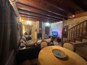 a living room with a table and a couch at St George Stonehouse Ioannina in Káto Lapsísta