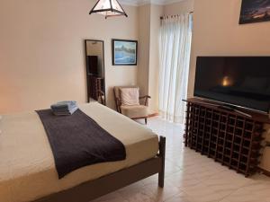 a bedroom with a bed and a flat screen tv at Alquilaencanarias Tabaiba vista mar in Tabaiba