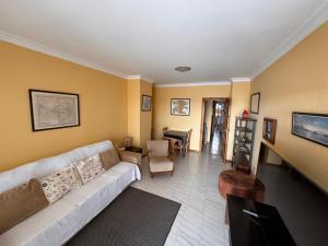 a living room with a couch and a table at Alquilaencanarias Tabaiba vista mar in Tabaiba