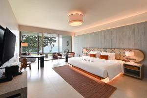 a bedroom with a large bed and a television at Rocky's Boutique Resort - Veranda Collection Samui in Lamai +37 photos