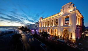 a large building on a city street at night at Hyatt Regency Nice Palais de la Méditerranée in Nice