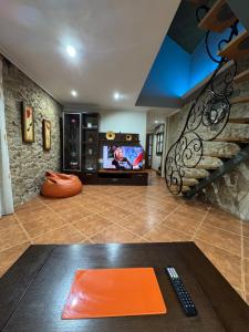 a living room with a tv and a couch and a table at Casa Costeira in Redondela
