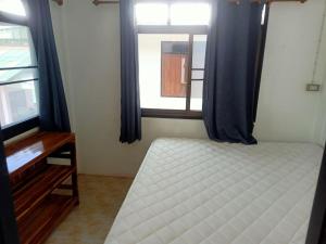 a bedroom with a bed and a window at Blue Lotus Resort in Baan Tai +75 photos