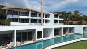 an exterior view of a building with a swimming pool at Rocky's Boutique Resort - Veranda Collection Samui in Lamai