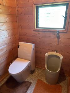 a bathroom with a toilet and a urinal at HIDEAWAYMountainLodge in Itoshima +7 photos