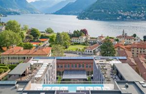 an aerial view of a city with a body of water at Hilton Lake Como in Como