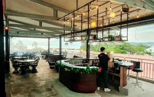 a man standing at a bar on a patio at Casablanca Hotel Condominium Resort in Olongapo