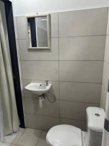a bathroom with a sink and a toilet at Villa Nola Dos in Port-of-Spain