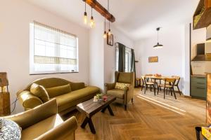 a living room with a couch and a table at Gora Apartments by the Forest in Vrdnik