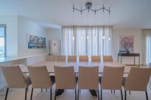 a dining room with a table and chairs at Art Apartment In Mamila - Mamila Residence in Jerusalem