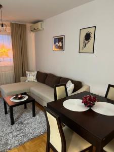 a living room with two tables and a couch at Apartman KIKA in Banja Luka +21 photos