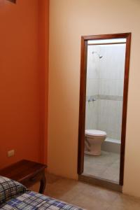 a bathroom with a toilet and a shower stall at Hotel Susibon in Olón