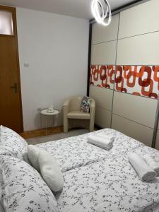 a bedroom with a bed with two towels on it at Apartman KIKA in Banja Luka